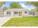 Charming single-story home with a well-maintained lawn and freshly painted white brick exterior at 3008 W Van Buren Dr, Tampa, FL 33611