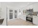 Contemporary kitchen with sleek white cabinets, stainless steel appliances, and backyard access at 3008 W Van Buren Dr, Tampa, FL 33611