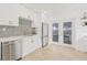 Bright kitchen featuring white cabinets, stainless steel appliances, and a view to the backyard at 3008 W Van Buren Dr, Tampa, FL 33611
