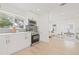 Stylish kitchen with stainless steel appliances, white cabinetry, and open access to the living area at 3008 W Van Buren Dr, Tampa, FL 33611
