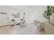 Inviting living room with a comfortable sofa, stylish rug, and plenty of natural light at 3008 W Van Buren Dr, Tampa, FL 33611