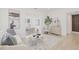 Cozy living room with modern decor and an open floor plan leading to the dining area at 3008 W Van Buren Dr, Tampa, FL 33611