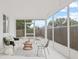 Bright sunroom features white brick walls, tile floors, and large windows offering a relaxing space at 3008 W Van Buren Dr, Tampa, FL 33611