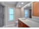 Updated bathroom with modern vanity, bright natural light, and a walk-in shower at 3053 Gregor Ct, Palm Harbor, FL 34684