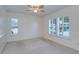 Spacious bedroom with neutral walls, carpet, and plantation shutters on the windows at 3053 Gregor Ct, Palm Harbor, FL 34684