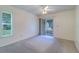 Bedroom with private access to an enclosed patio. Large window with plantation shutters at 3053 Gregor Ct, Palm Harbor, FL 34684