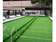 Bocce ball courts with green turf and ample seating under covered patios at 3053 Gregor Ct, Palm Harbor, FL 34684