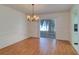 Open dining space with wood-look flooring and view to a screened patio at 3053 Gregor Ct, Palm Harbor, FL 34684