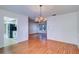 Bright dining area with a chandelier, wood-look flooring, and view to the kitchen at 3053 Gregor Ct, Palm Harbor, FL 34684