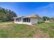Side exterior of home featuring a large screened in porch at 3053 Gregor Ct, Palm Harbor, FL 34684