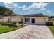 Charming single-story home features a manicured lawn and a two-car garage at 3053 Gregor Ct, Palm Harbor, FL 34684