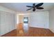 Bright living room featuring wood-look flooring, ceiling fan, and view to the lanai at 3053 Gregor Ct, Palm Harbor, FL 34684