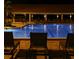 Outdoor swimming pool with lights reflecting in the water and lounge chairs on the patio at 3053 Gregor Ct, Palm Harbor, FL 34684