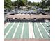 Birds eye view of multiple shuffleboard courts with covered seating, surrounded by parked cars at 3053 Gregor Ct, Palm Harbor, FL 34684