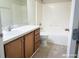Bathroom features a sink with cabinets and a shower-tub combination with tiled walls at 3095 Coronet Ct, Spring Hill, FL 34609