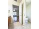 Bathroom view featuring vanity area, toilet, and doorway to another room with hardwood flooring at 3095 Coronet Ct, Spring Hill, FL 34609