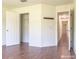 Bright bedroom with hardwood floors, closet, coat rack and view of the hallway at 3095 Coronet Ct, Spring Hill, FL 34609