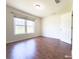 This bright bedroom features hardwood floors and a large window with natural light at 3095 Coronet Ct, Spring Hill, FL 34609