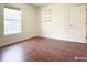 An inviting bedroom with hardwood floors, ample light, and built-in shelving at 3095 Coronet Ct, Spring Hill, FL 34609