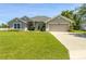 Charming one-story home with a lush green lawn and two car garage at 3095 Coronet Ct, Spring Hill, FL 34609