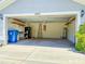 Spacious two-car garage featuring ample storage, shelving, and lighting at 3095 Coronet Ct, Spring Hill, FL 34609