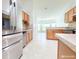 Well-appointed kitchen with counter seating and stainless steel refrigerator at 3095 Coronet Ct, Spring Hill, FL 34609