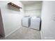 Laundry room is equipped with washer, dryer, and shelving for organizing at 3095 Coronet Ct, Spring Hill, FL 34609