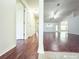 Open-concept living space with hardwood floors, and several doorways and windows that bring in natural light at 3095 Coronet Ct, Spring Hill, FL 34609