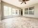 Screened patio with ceiling fan, tile floor, and multiple windows at 3095 Coronet Ct, Spring Hill, FL 34609
