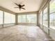 Spacious screened patio with tile flooring, offering views of lush greenery at 3095 Coronet Ct, Spring Hill, FL 34609