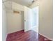 Walk-in closet with built-in shelving, wooden floors, and doorway leading to an adjacent bathroom at 3095 Coronet Ct, Spring Hill, FL 34609