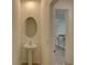 Half bath features a pedestal sink and an oval mirror at 33062 Frosted Clover Way, Wesley Chapel, FL 33545