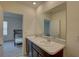 Bright bathroom with double sink vanity and doorway leading to a bedroom with a bunk bed at 33062 Frosted Clover Way, Wesley Chapel, FL 33545