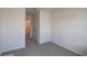 Neutral bedroom features carpeted floors, closet for storage, and a hallway leading to other rooms at 33062 Frosted Clover Way, Wesley Chapel, FL 33545