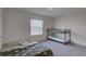 Bedroom features a bed, bunk bed, window with blinds, and carpeted floors at 33062 Frosted Clover Way, Wesley Chapel, FL 33545