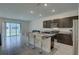 Open kitchen with granite counters, stainless appliances, and a breakfast bar overlooks the living space for seamless entertaining at 33062 Frosted Clover Way, Wesley Chapel, FL 33545