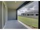 Covered patio area offers a comfortable outdoor space with a view of the grassy backyard and fence at 33062 Frosted Clover Way, Wesley Chapel, FL 33545