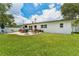 Enjoy outdoor living on a stone patio with grill, and manicured lawn at 3418 W Bay Ave, Tampa, FL 33611