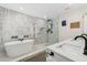 Luxurious bathroom featuring a soaking tub, glass shower, and elegant tile work at 3418 W Bay Ave, Tampa, FL 33611