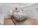 Cozy bedroom with a comfortable bed, neutral tones, and a ceiling fan at 3418 W Bay Ave, Tampa, FL 33611