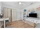 Spacious bedroom featuring light wood floors, white walls, a ceiling fan, and plenty of storage and natural light at 3418 W Bay Ave, Tampa, FL 33611