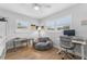 Comfortable bedroom featuring a soft chair, neutral colors, wood floors, and bright windows with white shutters at 3418 W Bay Ave, Tampa, FL 33611