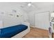 Inviting bedroom with bright walls, wood floors, and closet with bi-fold doors at 3418 W Bay Ave, Tampa, FL 33611