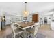 Cozy dining room featuring decorative light fixture, opening to living room and kitchen at 3418 W Bay Ave, Tampa, FL 33611