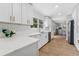 Modern kitchen showcasing white cabinetry, a stylish sink, and wood-look flooring at 3418 W Bay Ave, Tampa, FL 33611