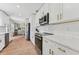 Bright kitchen featuring white cabinets, stainless steel appliances, and marble countertops at 3418 W Bay Ave, Tampa, FL 33611