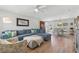 Bright living room with new floors, ceiling fan, large sectional sofa and connecting dining room at 3418 W Bay Ave, Tampa, FL 33611