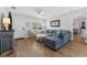 Bright living room with new floors, ceiling fan and large sectional sofa at 3418 W Bay Ave, Tampa, FL 33611