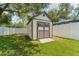 Backyard shed in a well-manicured yard, offering extra storage space at 3418 W Bay Ave, Tampa, FL 33611