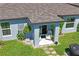 A charming covered back porch with seating, potted plants, and decorative accents at 3611 Natural Trace St, Plant City, FL 33565